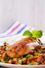 Fried chicken breast with sauteed vegetables: eggplant, carrot, zucchini, squash and tomatoes