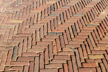 Old inlaid brick paving, Old  paving made of red bricks. Background concept. Architecture concept.