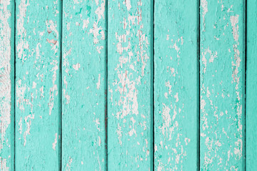 Old wooden planks with cracked turquoise paint
