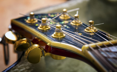 Obraz premium Red acoustic guitar close up in dark background