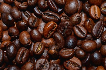 Fresh roasted coffee beans background, texture. Arabica bean wallpaper, close-up.