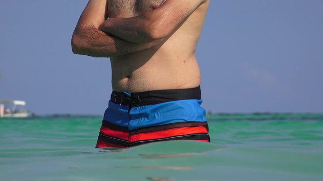 Male Swimmer Posing With Swimsuit In Ocean