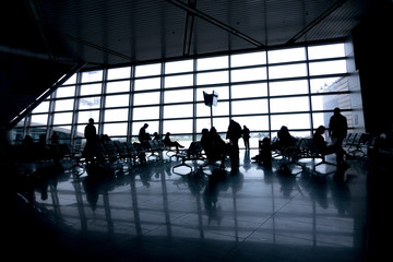 Silhouettes of people in modern airport