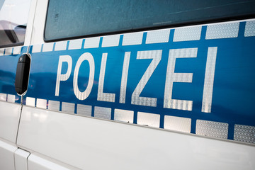 German police sign on the patrol car