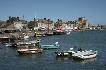 Fototapeta na wymiar The coastal commune of Barfleur in Normandy northwest France. Boats berthed in the small harbor