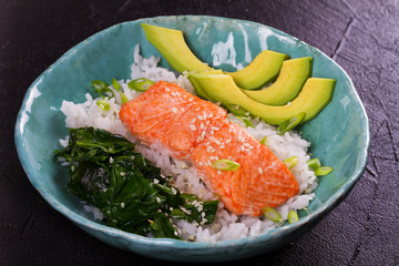 Salmon with spinach and avocado. Rice as a garnish