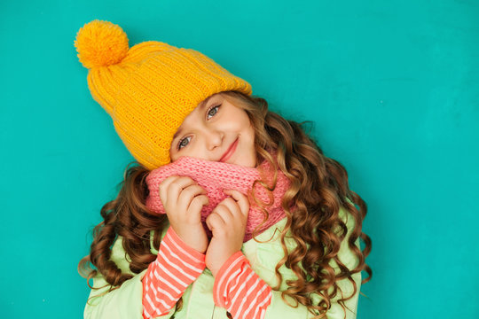Cute little lady wearing yellow woolen cap and scarf