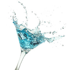 blue cocktail splashing in martini glass isolated on white