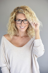 Fototapeta premium Portrait of attractive blond woman with eyeglasses, isolated