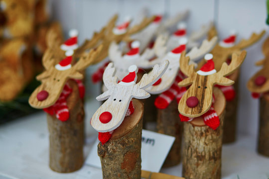Funny wooden moose deers with red noses and Santa hats