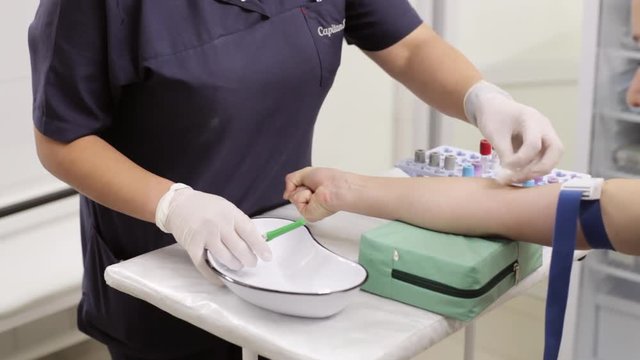 Nurse And Female Patient. Nurse Is Drawing Blood Sample In Hospital Or Clinic.