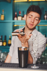 Barman's hands making shot cocktail