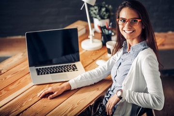 Young female working sitting at a desk