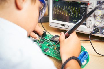 Young boy working on an electronics project