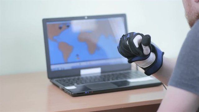 Electronic robotic cyber glove. Man plays VR game operating with 3D bionic simulator glove. HD.