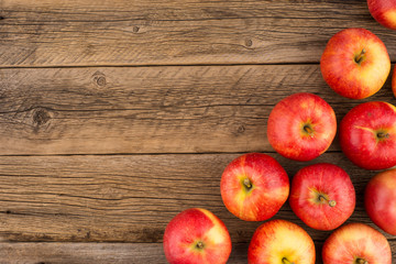 Red apples on the old wooden table.