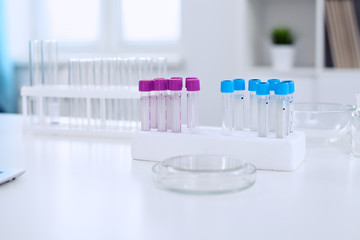 Research laboratory working space. Test tubes and tablet PC are lying at the table. Medical equipment. Blood test