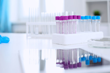 Research laboratory working space. Test tubes and tablet PC are lying at the table. Medical equipment. Blood test