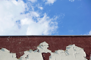 damaged wall detail and blue sky