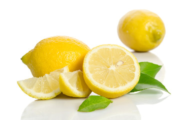 Two lemons and half with leaves  isolated on white background