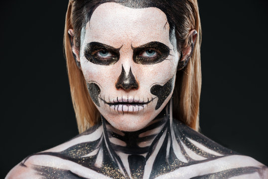 Closeup of young woman with terrifying skeleton makeup