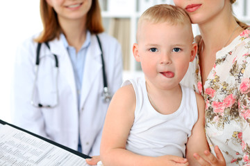 Little boy child  with his mother  after health exam at doctor's office