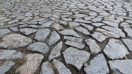 Cobble stone floor on sidewalk - texture background, focus on foreground.