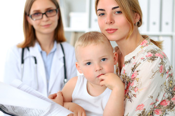 Little boy child  with his mother  after health exam at doctor's office