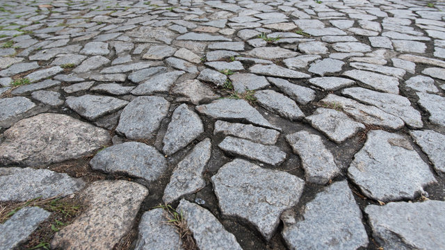 Cobble stone floor on sidewalk - texture background, focus on foreground.