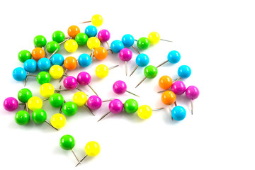 colorful push pins on white background.