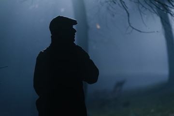 Man walking through the dark