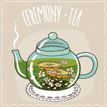 Fototapeta Transparent glass teapot with hot brewed tea with jasmine, lie on a lacy napkin. Beige background and ornate lettering Ceremony tea. Handmade cartoon style