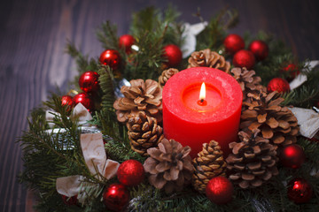 Fototapeta na wymiar Decorated Christmas wreath with a candle close-up