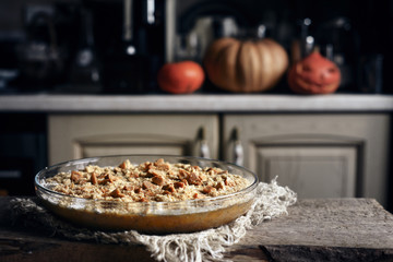 Raw pumpkin dump cake in the baking dish on the wooden table