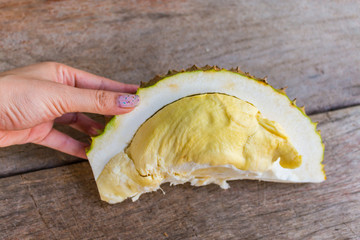 Close up Durian on woman hands  on the wood table