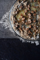 Raw pumpkin dump cake in the baking dish on the wooden table vertical