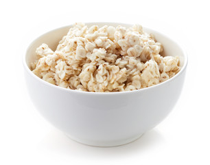 Bowl of barley porridge isolated on white