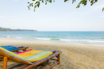 Sun-beds on a bounty beach with a blue sea