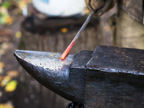 Red Hot Iron Rod On Anvil