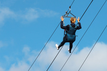 Woman descends on a zipline