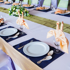 Table with the glasses and plates for party