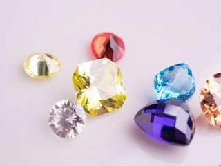 Jewel or gems on White shine color, Collection of many different natural gemstones 
amethyst, lapis lazuli, rose quartz, citrine, ruby, amazonite, moonstone, labradorite, chalcedony, blue topaz