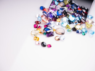 Jewel or gems on White shine color, Collection of many different natural gemstones 
amethyst, lapis lazuli, rose quartz, citrine, ruby, amazonite, moonstone, labradorite, chalcedony, blue topaz