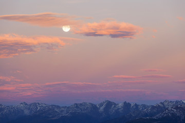 Mountain peaks with full moon