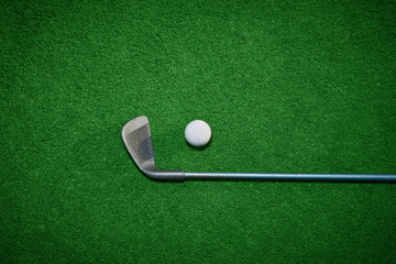 Golf ball and Golf Club on Artificial Grass vignetted