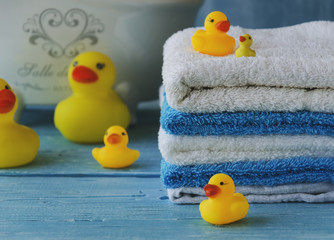 stack of colorful towels and bath duck on the table