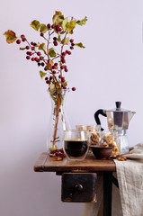 Still life with coffee, nuts and small apples