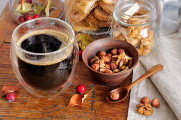 Still life with coffee, nuts and small apples
