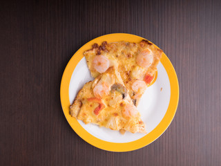 shrimp cocktail pizza with tomato and pineapple on brown wood table