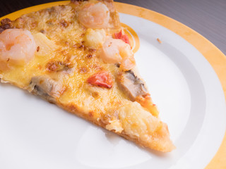 shrimp cocktail pizza with tomato and pineapple on brown wood table